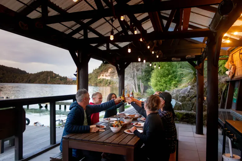 Guests toasting at the lakeside gourmet dinner after the Starlight paddle