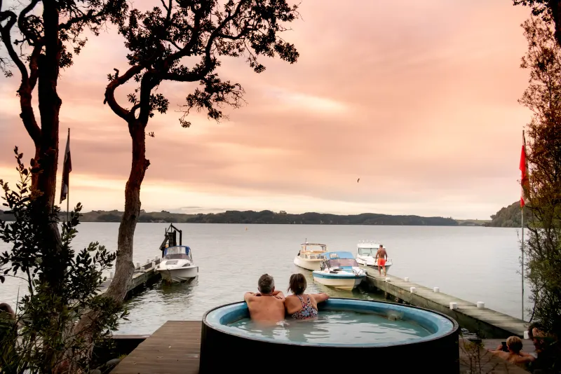 Relaxing in the Manupirua hot pools as the sun sets over Lake Rotoiti